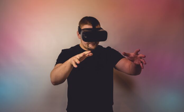 a man in a black shirt is using a virtual device