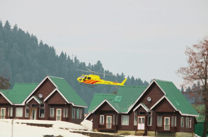 a helicopter flying over a row of houses