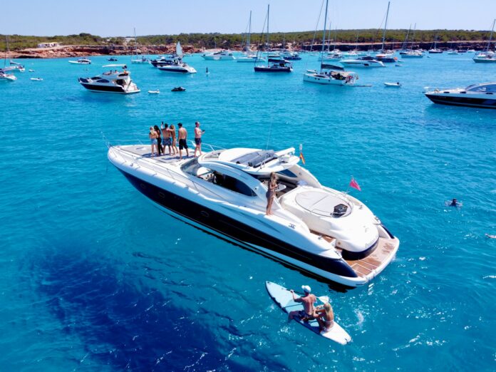 a group of people standing on a boat in the water