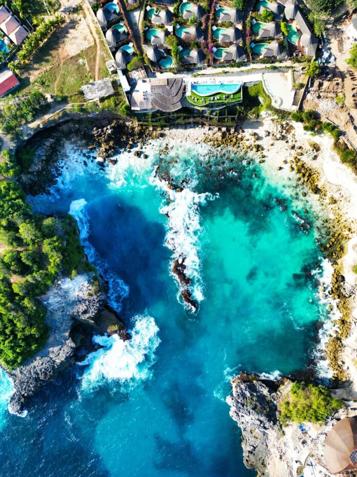 An aerial view of a resort and a body of water