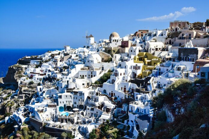 a view of a hillside with white buildings on it