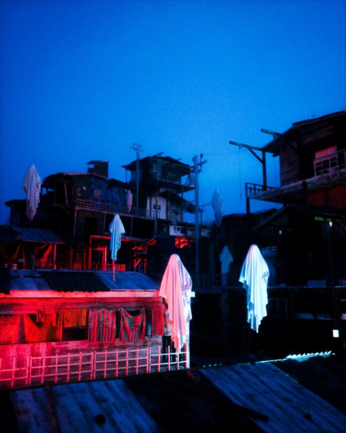 a group of buildings with red lights