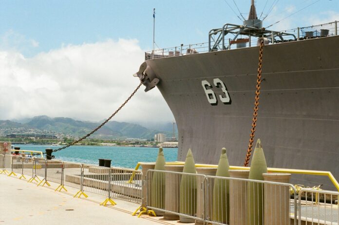 a large boat docked at a pier near the water