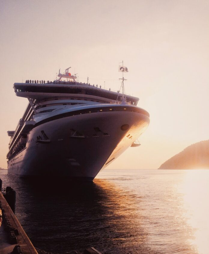 a large cruise ship in the water near a dock