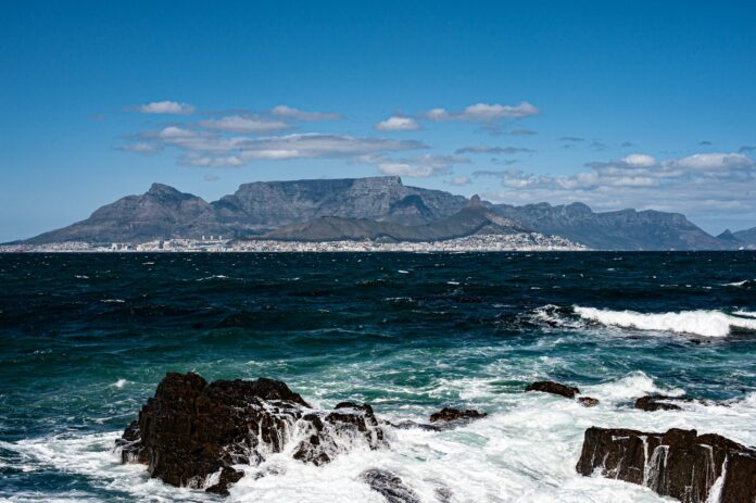 a large body of water with a mountain in the background