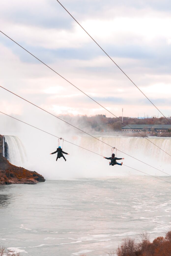 two person riding on the rides over body of water