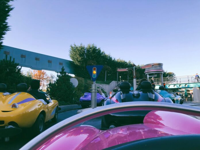 a group of people riding in bumper cars down a street